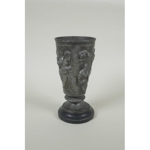 31 - An antique French Grand Tour pewter goblet on a slate socle, with raised Greco Roman figural decorat... 