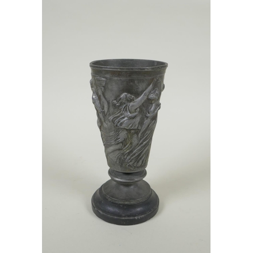 31 - An antique French Grand Tour pewter goblet on a slate socle, with raised Greco Roman figural decorat... 