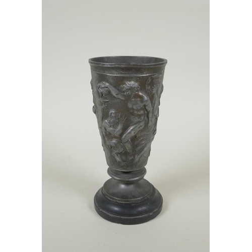 31 - An antique French Grand Tour pewter goblet on a slate socle, with raised Greco Roman figural decorat... 