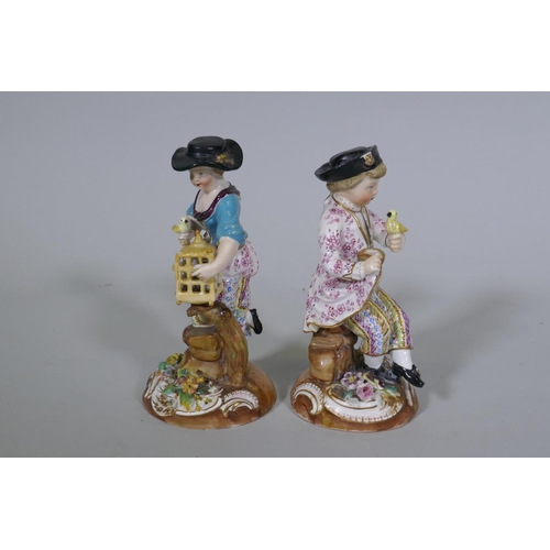 36 - A pair of Continental hard paste porcelain figures, boy with a bird and a birdseller, factory mark t... 