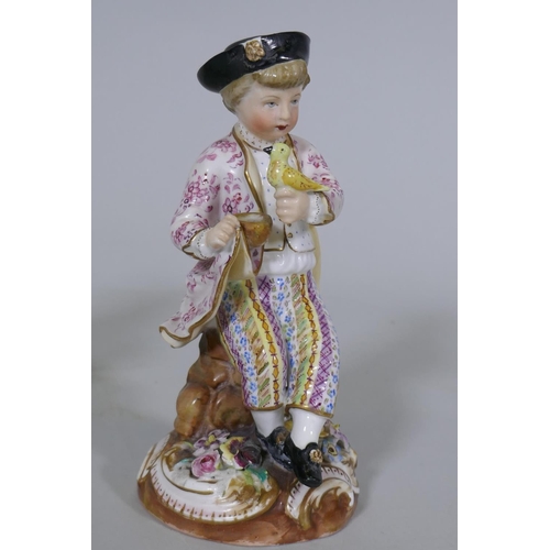 36 - A pair of Continental hard paste porcelain figures, boy with a bird and a birdseller, factory mark t... 