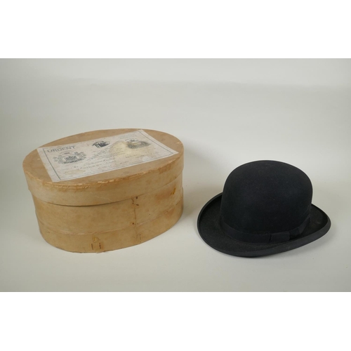 41 - A vintage G.A. Dunn & Co bowler hat, a vintage silk top hat, an antique leather top hat case and... 