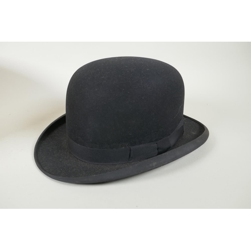 41 - A vintage G.A. Dunn & Co bowler hat, a vintage silk top hat, an antique leather top hat case and... 