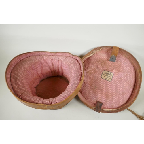 41 - A vintage G.A. Dunn & Co bowler hat, a vintage silk top hat, an antique leather top hat case and... 