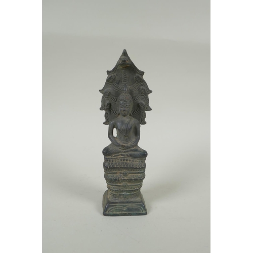 52 - A Cambodian filled bronze figure of Buddha seated on a cobra throne, 22cm high