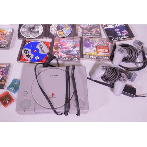 56 - A Sony PlayStation and two controllers, games etc, a Sharp 700 personal computer, M2-731, and an Ams... 