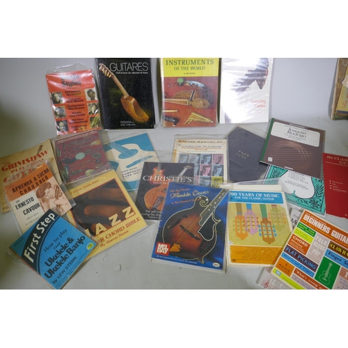 59 - A collection of books, musical instruments, folk and African, guitars and instruction manuals