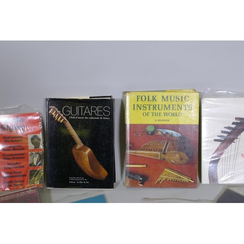 59 - A collection of books, musical instruments, folk and African, guitars and instruction manuals