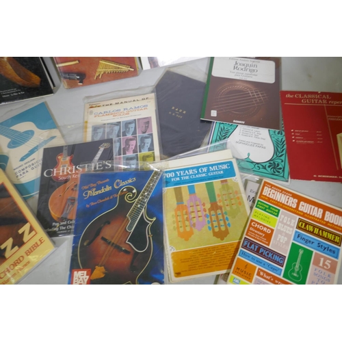 59 - A collection of books, musical instruments, folk and African, guitars and instruction manuals