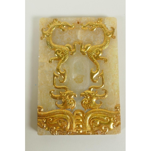 61 - A Chinese carved and gilt jade tablet with archaic phoenix and dragon decoration, 8 x 12cm