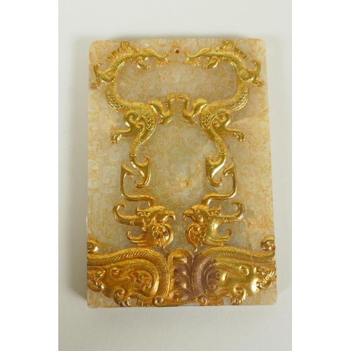 61 - A Chinese carved and gilt jade tablet with archaic phoenix and dragon decoration, 8 x 12cm