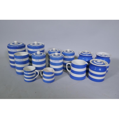 64 - A quantity of Cornish ware pottery, three T&G Green jars and covers and a milk jug, the remainde... 