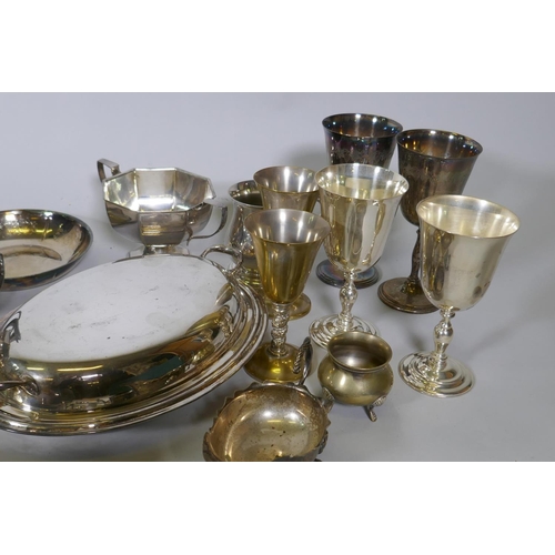 668 - A quantity of silver plate to include a three piece tea set, serving tureens, goblets, etc, and a qu... 