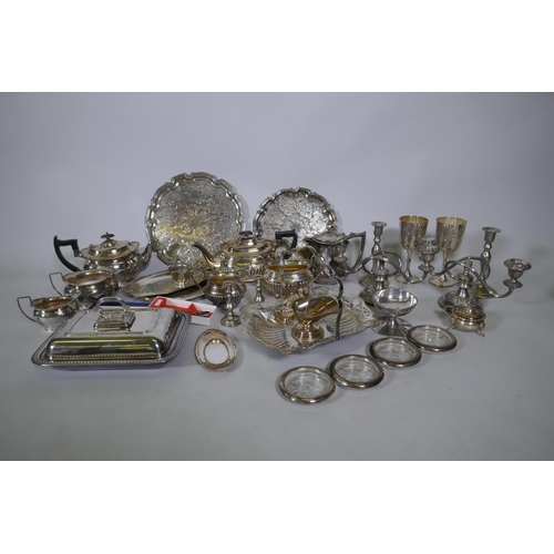 669 - A quantity of silver plate to include tea sets, serving trays, coasters, goblets etc