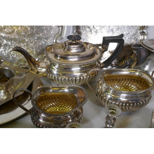 669 - A quantity of silver plate to include tea sets, serving trays, coasters, goblets etc