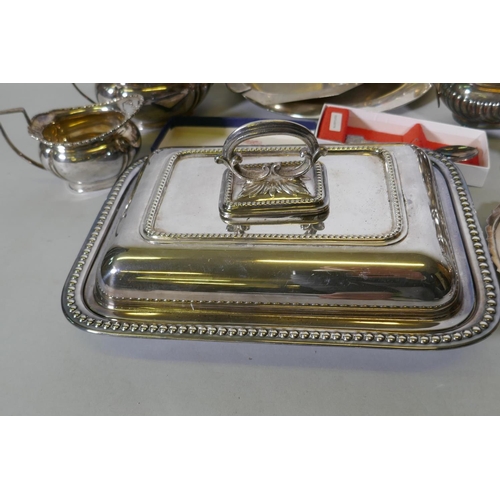 669 - A quantity of silver plate to include tea sets, serving trays, coasters, goblets etc