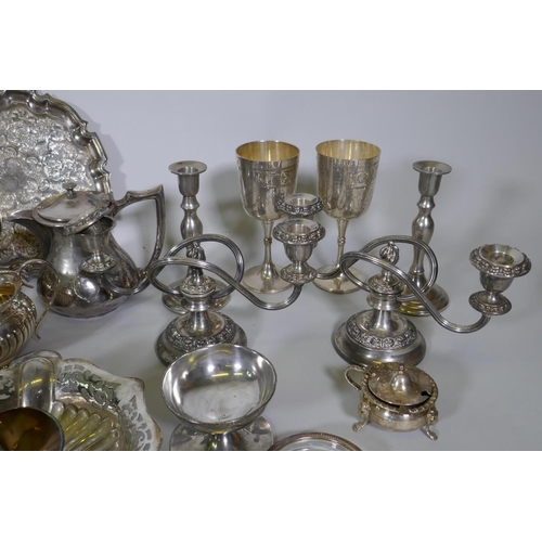 669 - A quantity of silver plate to include tea sets, serving trays, coasters, goblets etc