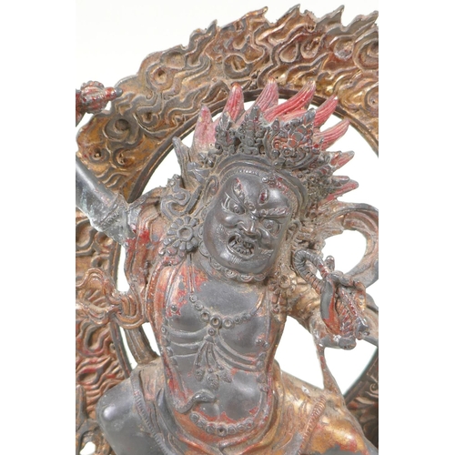 70 - A Tibetan bronze figure of Vajrapani with remnants of gilt patina, 24cm high