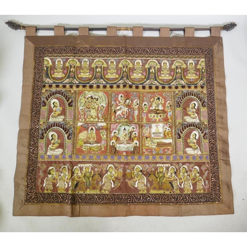 74 - An antique Tibetan embroidered and beaded silk textile hanging, decorated with depictions of Buddha,... 