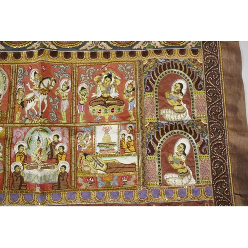 74 - An antique Tibetan embroidered and beaded silk textile hanging, decorated with depictions of Buddha,... 