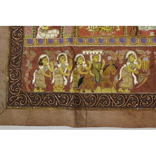 74 - An antique Tibetan embroidered and beaded silk textile hanging, decorated with depictions of Buddha,... 