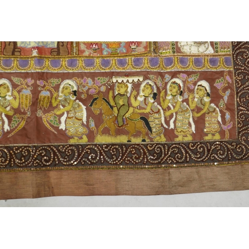 74 - An antique Tibetan embroidered and beaded silk textile hanging, decorated with depictions of Buddha,... 