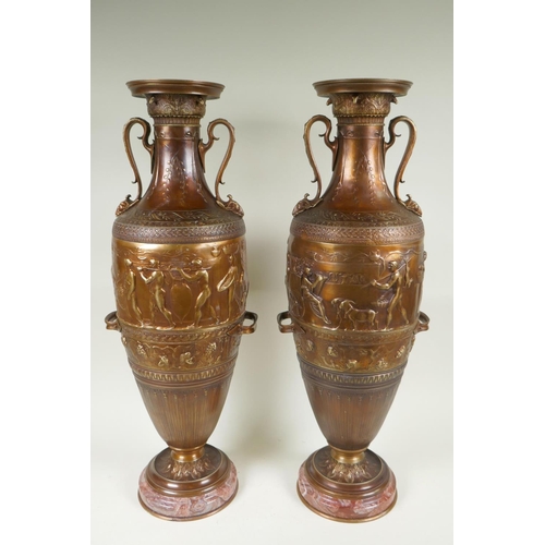 77 - After Barbedienne, a pair of bronze Grand Tour style urns with two handles and raised figural decora... 