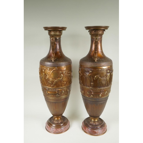 77 - After Barbedienne, a pair of bronze Grand Tour style urns with two handles and raised figural decora... 