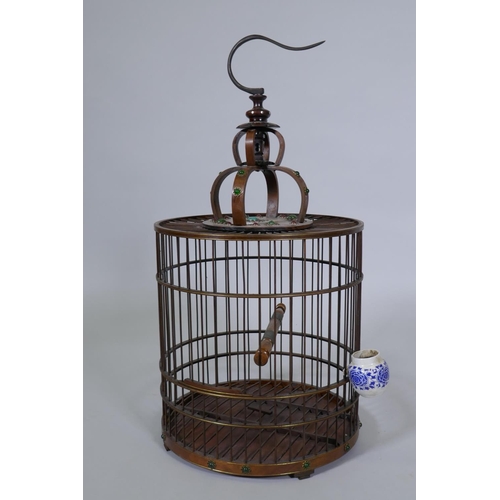 79 - A Chinese wood bird cage with inset decoration, 68cm high