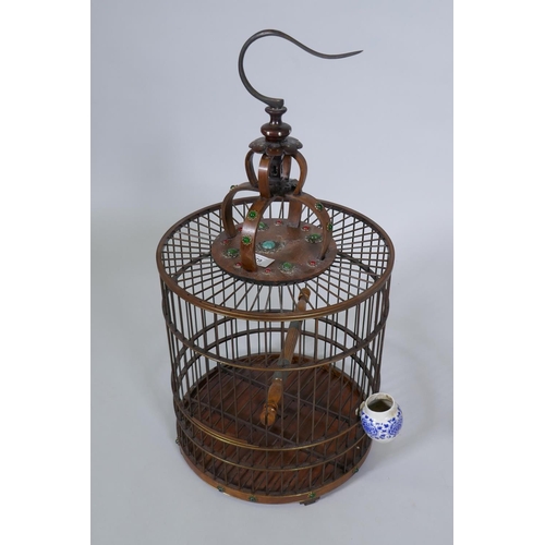 79 - A Chinese wood bird cage with inset decoration, 68cm high