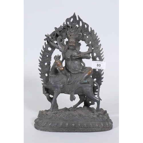 80 - A Sino-Tibetan bronze figure of a deity on horseback, 32cm high