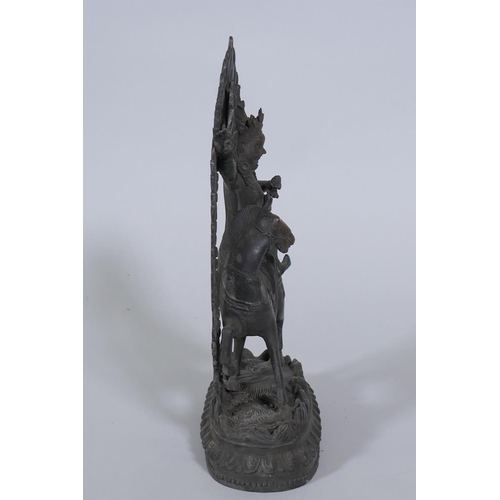 80 - A Sino-Tibetan bronze figure of a deity on horseback, 32cm high