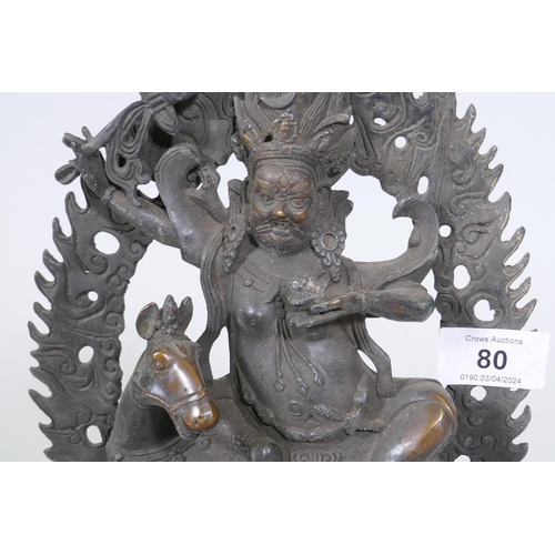 80 - A Sino-Tibetan bronze figure of a deity on horseback, 32cm high