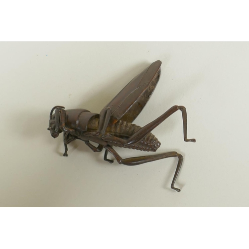 86 - A Japanese style bronze okimono grasshopper, with articulated limbs, 8cm long