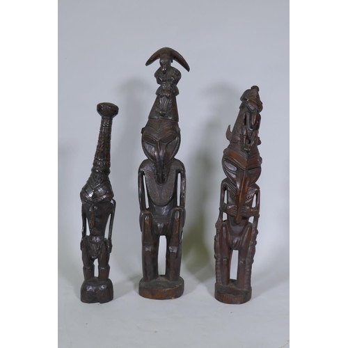 9 - Three Papua New Guinea carved wood tribal figures, largest 64cm high