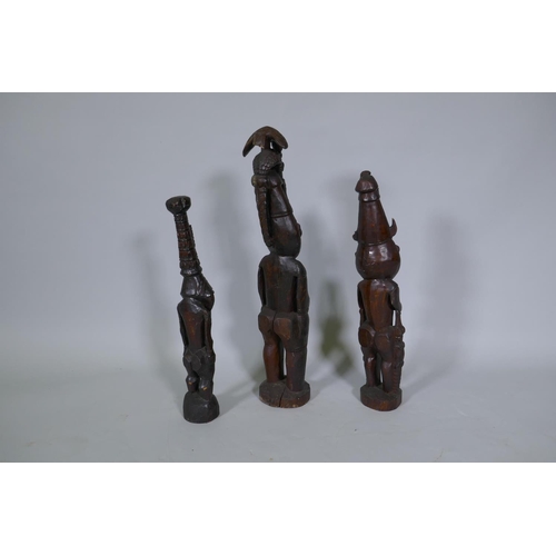 9 - Three Papua New Guinea carved wood tribal figures, largest 64cm high