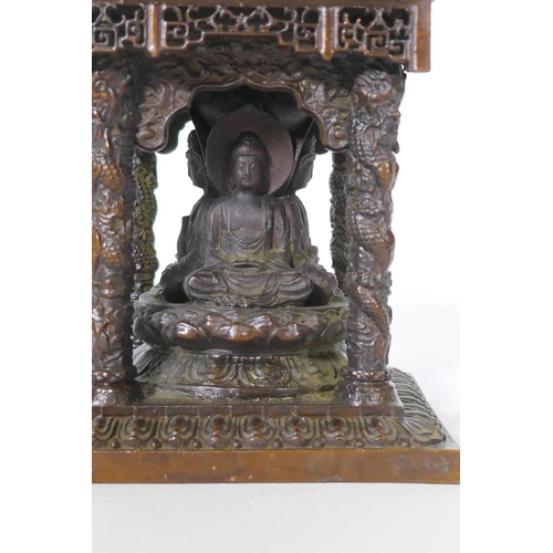 92 - A bronze model of a shrine with pagoda roof and three Buddhas, 15cm high