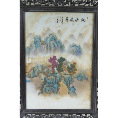 95 - A Chinese porcelain and carved hardwood table screen decorated with a mountain landscape, 68cm high