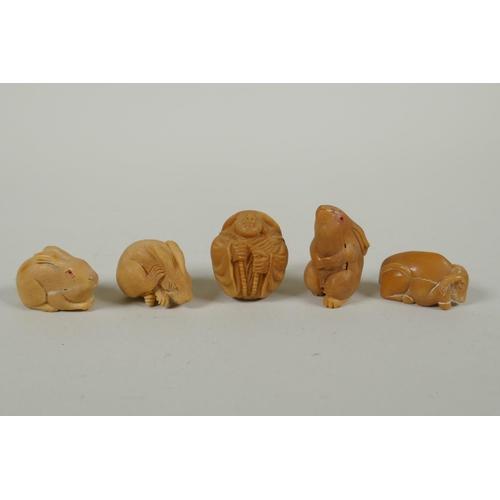 97 - Five Japanese carved tagua nut netsuke in the form of hares, a buffalo and a Buddha, largest 4cm