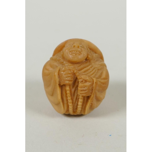 97 - Five Japanese carved tagua nut netsuke in the form of hares, a buffalo and a Buddha, largest 4cm