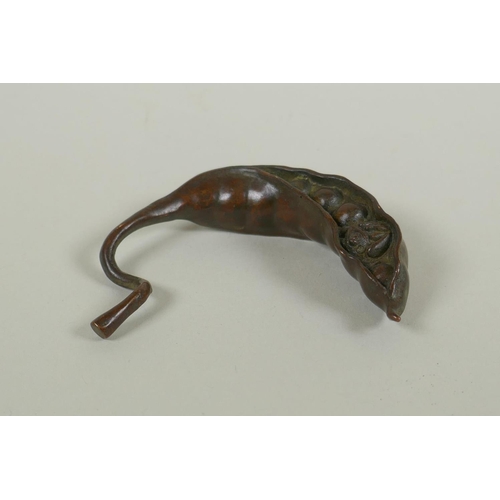 99 - A Japanese style bronze okimono of a frog nestled in a pea pod 7cm long