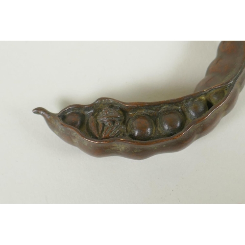 99 - A Japanese style bronze okimono of a frog nestled in a pea pod 7cm long