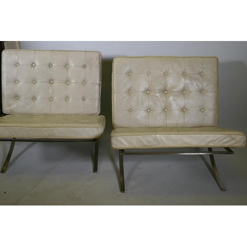 1070 - A pair of Barcelona style chairs, chromed steel frames and leather cushions, lack webbing