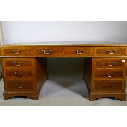 1112 - A Georgian style mahogany pedestal partner's desk, with nine drawers and two cupboards, brass swan n... 