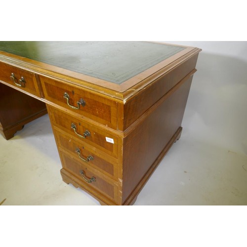 1112 - A Georgian style mahogany pedestal partner's desk, with nine drawers and two cupboards, brass swan n... 