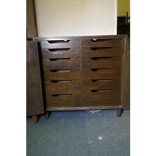 1116 - A mid-century cherry wood press cupboard, the two folding drawers opening to reveal twelve slide dra... 