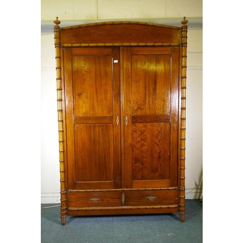 1120 - A Dutch C19th polished pitch pine knockdown armoire, with two doors flanked by faux bamboo columns, ... 