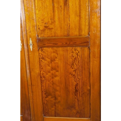 1120 - A Dutch C19th polished pitch pine knockdown armoire, with two doors flanked by faux bamboo columns, ... 