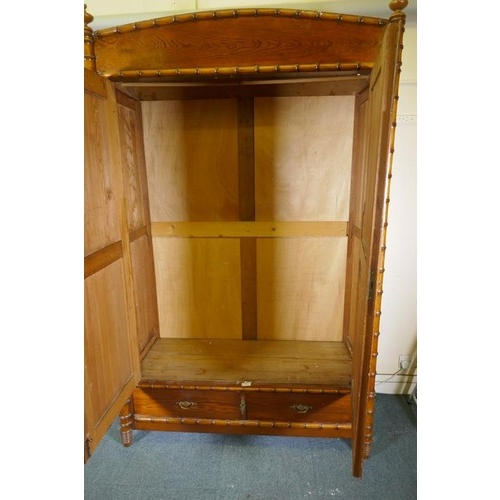 1120 - A Dutch C19th polished pitch pine knockdown armoire, with two doors flanked by faux bamboo columns, ... 