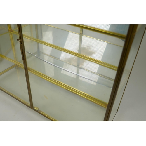 186 - Two mirror back brass display cases, largest 29 x 36cm